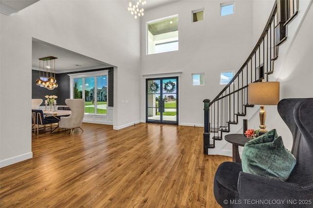 17076 S 31st E Ave, Mounds, OK 74047 - entryway with a chandelier, wood finished floors, stairway, and a towering ceiling