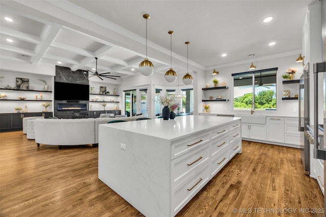 17076 S 31st E Ave, Mounds, OK 74047 - kitchen with open shelves, a ceiling fan, recessed lighting, white cabinetry, and wood finished floors