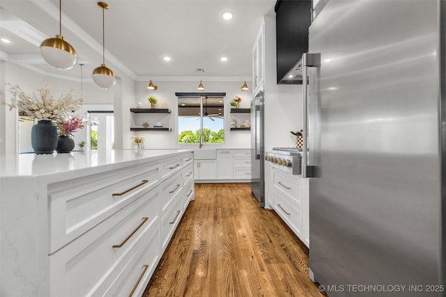 17076 S 31st E Ave, Mounds, OK 74047 - kitchen with stainless steel appliances, open shelves, white cabinets, wood finished floors, and recessed lighting