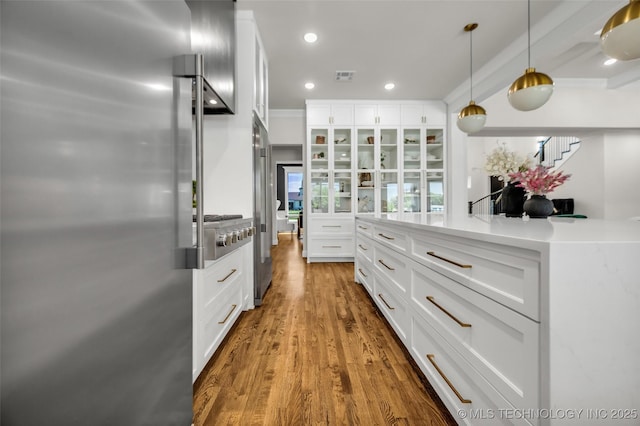17076 S 31st E Ave, Mounds, OK 74047 - kitchen featuring appliances with stainless steel finishes, white cabinets, wood finished floors, recessed lighting, and hanging light fixtures