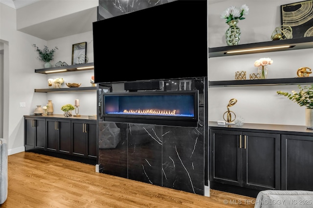 17076 S 31st E Ave, Mounds, OK 74047 - detailed view of wood finished floors and a lit fireplace