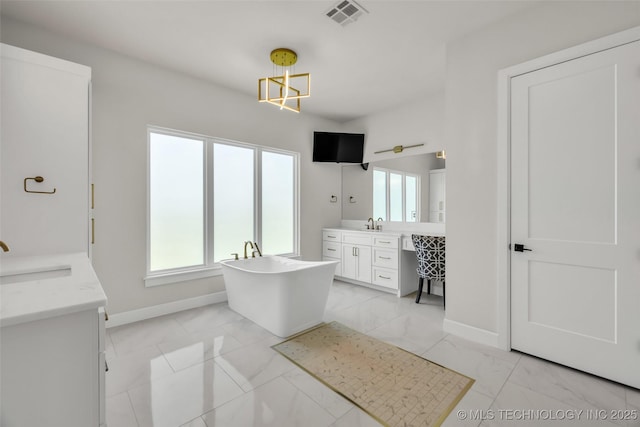 17076 S 31st E Ave, Mounds, OK 74047 - bathroom with marble finish floors, two vanities, a soaking tub, and plenty of natural light