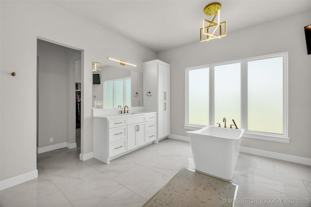 17076 S 31st E Ave, Mounds, OK 74047 - bathroom featuring marble finish flooring, vanity, a freestanding bath, and a walk in closet