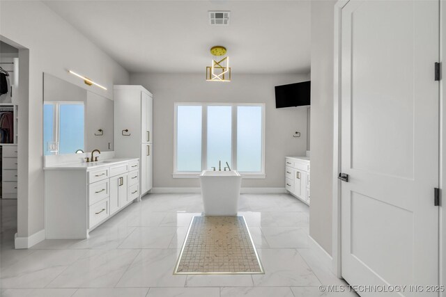 17076 S 31st E Ave, Mounds, OK 74047 - bathroom featuring marble finish floors, vanity, a freestanding bath, and a walk in closet
