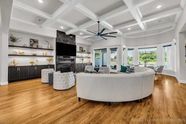 17076 S 31st E Ave, Mounds, OK 74047 - living room featuring light wood-type flooring, coffered ceiling, a ceiling fan, beamed ceiling, and a chandelier