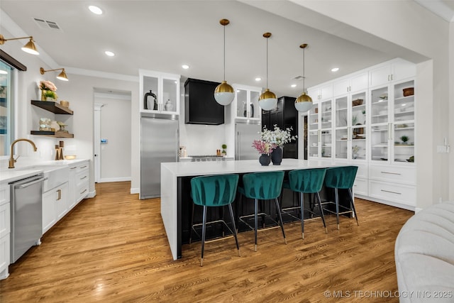 17076 S 31st E Ave, Mounds, OK 74047 - kitchen with appliances with stainless steel finishes, open shelves, white cabinetry, light countertops, and recessed lighting