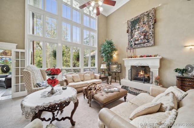 1115 Renaissance Dr, Sand Springs, OK 74063 - living area with a high ceiling, ceiling fan, and a lit fireplace