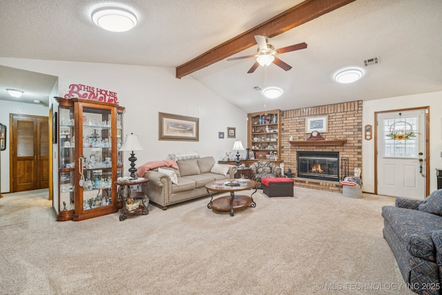 9901 N 107th E Ave, Owasso, OK 74055 - living room with carpet floors, a ceiling fan, a fireplace, and a textured ceiling