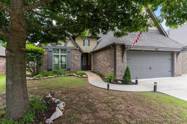 2610 E 139th St S, Jenks, OK 74008 - view of front facade with an attached garage, brick siding, and driveway