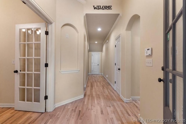 2610 E 139th St S, Jenks, OK 74008 - hall with light wood finished floors and arched walkways