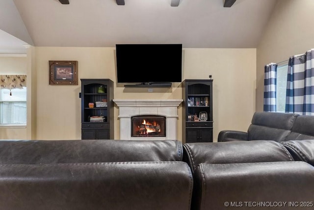 2610 E 139th St S, Jenks, OK 74008 - living area featuring lofted ceiling, a warm lit fireplace, and a ceiling fan