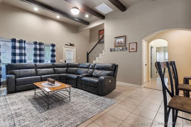 2610 E 139th St S, Jenks, OK 74008 - living room featuring arched walkways, beamed ceiling, light tile patterned floors, a high ceiling, and recessed lighting