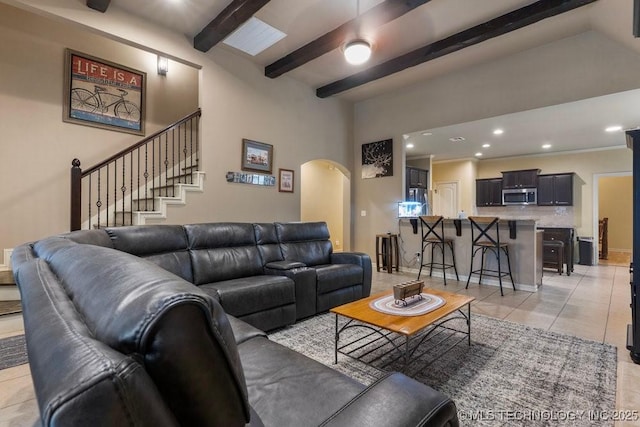 2610 E 139th St S, Jenks, OK 74008 - living area with arched walkways, light tile patterned flooring, beamed ceiling, recessed lighting, and stairs