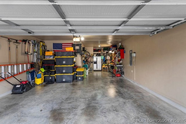 2610 E 139th St S, Jenks, OK 74008 - garage with stainless steel refrigerator with ice dispenser and baseboards