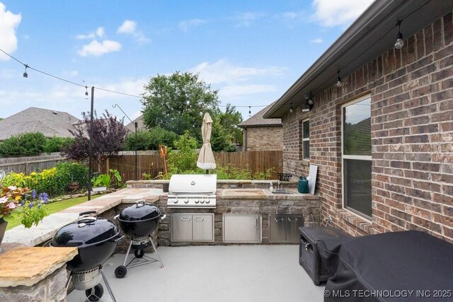2610 E 139th St S, Jenks, OK 74008 - fenced backyard with an outdoor kitchen and a patio area