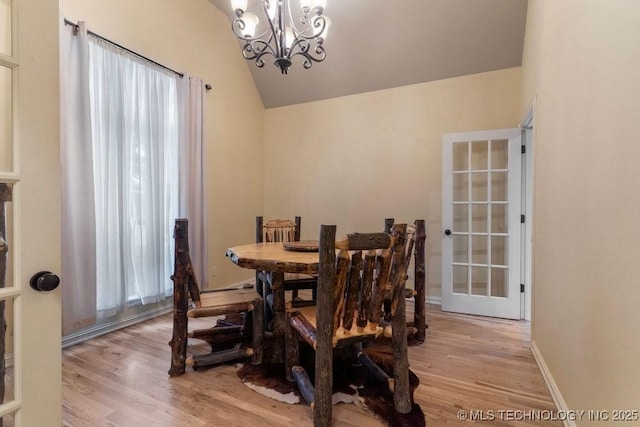 2610 E 139th St S, Jenks, OK 74008 - dining area featuring light wood finished floors, a chandelier, and vaulted ceiling