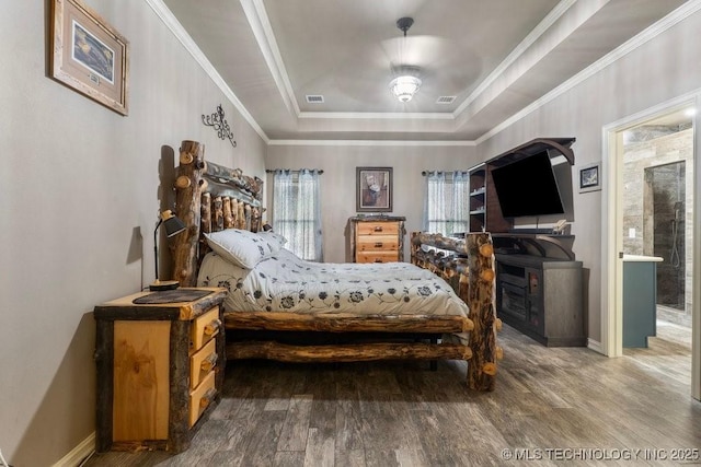2610 E 139th St S, Jenks, OK 74008 - bedroom featuring a tray ceiling, wood finished floors, and crown molding