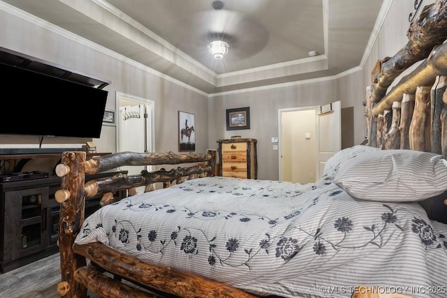 2610 E 139th St S, Jenks, OK 74008 - bedroom featuring a tray ceiling, ornamental molding, and wood finished floors