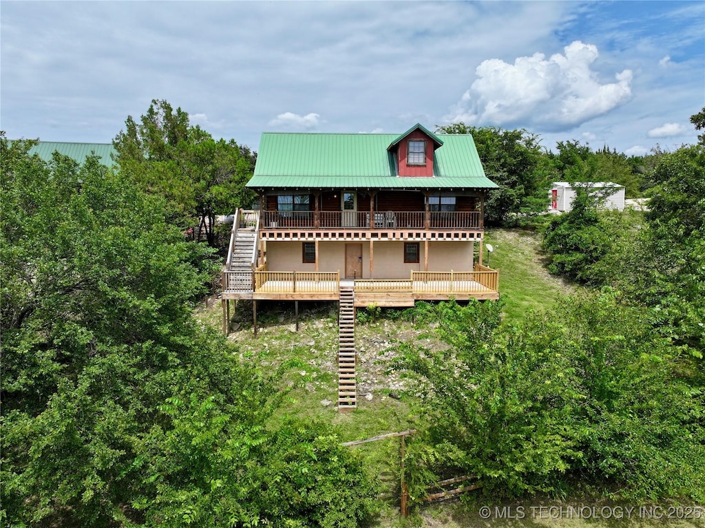 115 Ridge Rdg, Sulphur, OK 73086 - rear view of house with stairs, a metal roof, and a deck