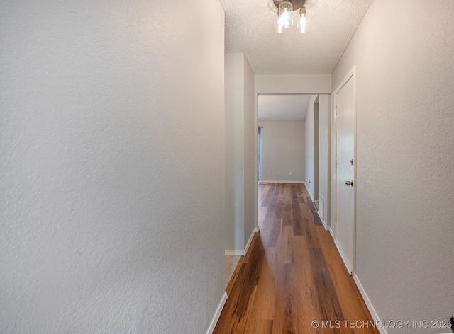 208 183rd E Ave, Tulsa, OK 74108 - corridor featuring wood finished floors and a textured ceiling