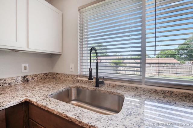 208 183rd E Ave, Tulsa, OK 74108 - kitchen view of white cabinetry and light stone countertops
