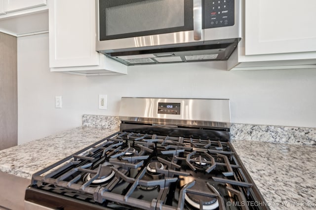 208 183rd E Ave, Tulsa, OK 74108 - kitchen view of appliances with stainless steel finishes, white cabinetry, and light stone countertops