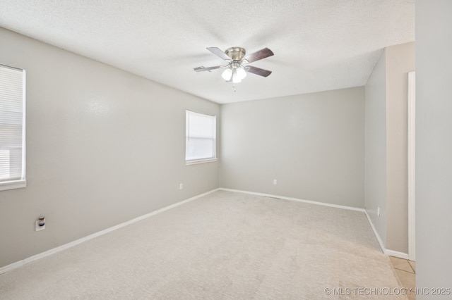 208 183rd E Ave, Tulsa, OK 74108 - spare room featuring a ceiling fan, light colored carpet, and a textured ceiling