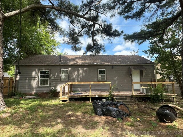 1208 S 9th, Mcalester, OK 74501 - rear view of house featuring a wooden deck and roof with shingles