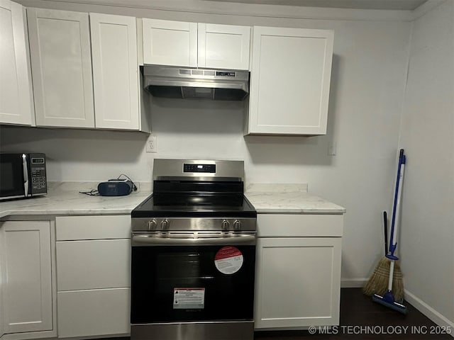 1208 S 9th, Mcalester, OK 74501 - kitchen featuring stainless steel range with electric stovetop, under cabinet range hood, black microwave, white cabinets, and light stone counters