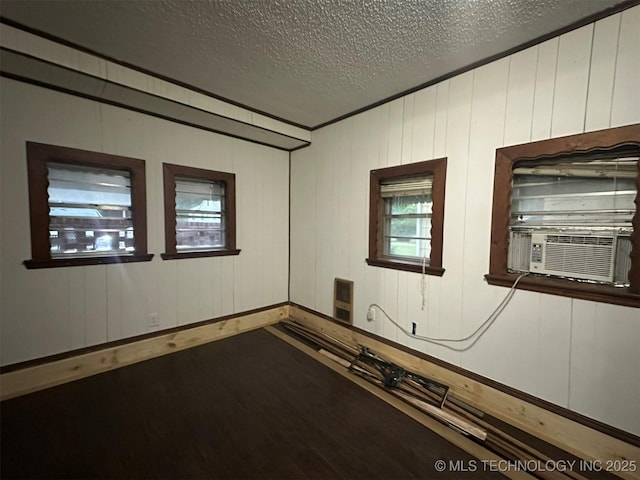1208 S 9th, Mcalester, OK 74501 - empty room with a textured ceiling, dark wood-style floors, and cooling unit