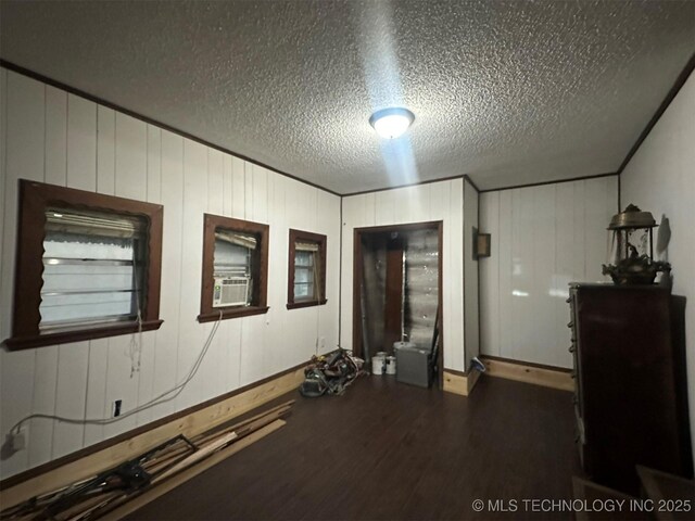 1208 S 9th, Mcalester, OK 74501 - unfurnished room featuring wood finished floors, cooling unit, and a textured ceiling