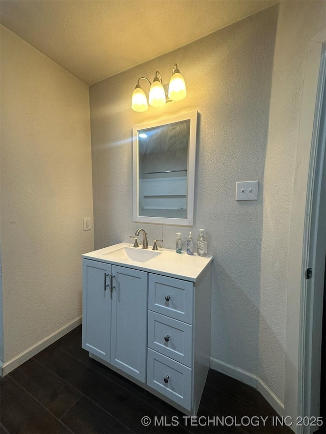 1208 S 9th, Mcalester, OK 74501 - bathroom featuring vanity and wood finished floors