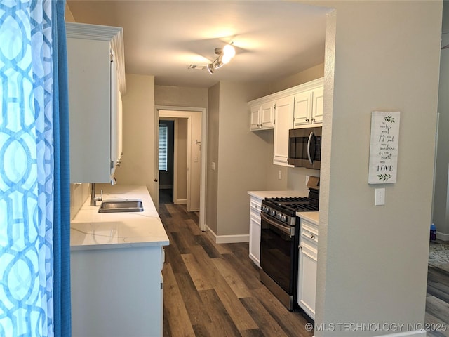 605 W 18th St S, Claremore, OK 74019 - kitchen featuring stainless steel appliances, dark wood-style floors, and white cabinets
