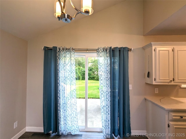 605 W 18th St S, Claremore, OK 74019 - dining room with vaulted ceiling, a chandelier, and dark wood-style flooring