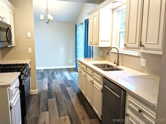 605 W 18th St S, Claremore, OK 74019 - kitchen with range with gas stovetop, dishwashing machine, stainless steel microwave, dark wood finished floors, and a chandelier