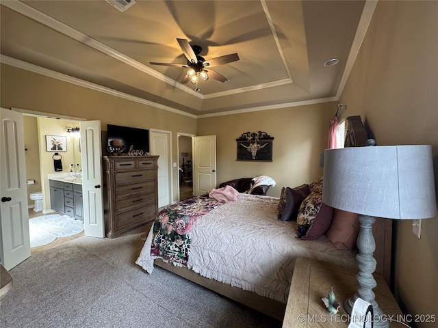 21902 W 13th St S, Sand Springs, OK 74063 - bedroom featuring a tray ceiling, light colored carpet, crown molding, ensuite bath, and ceiling fan