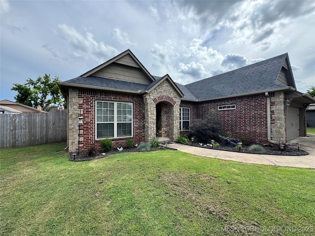 21902 W 13th St S, Sand Springs, OK 74063 - view of front of home featuring brick siding, an attached garage, roof with shingles, and stone siding