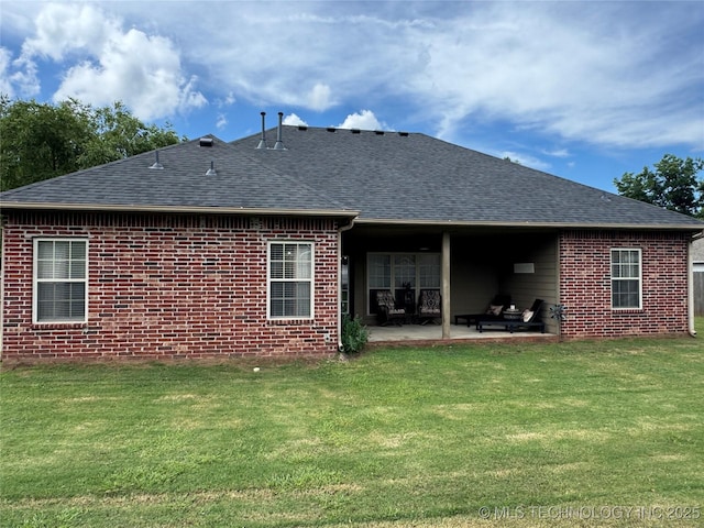21902 W 13th St S, Sand Springs, OK 74063 - back of property with roof with shingles, a patio, a yard, and brick siding
