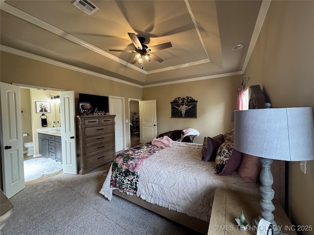 21902 W 13th St S, Sand Springs, OK 74063 - carpeted bedroom featuring a tray ceiling, crown molding, ensuite bathroom, and ceiling fan