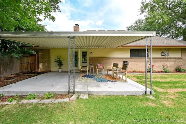 3948 S 93rd E Ave, Tulsa, OK 74145 - back of house with brick siding, a chimney, and a patio area