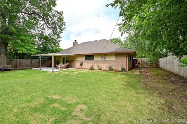 3948 S 93rd E Ave, Tulsa, OK 74145 - rear view of house featuring a patio area, a fenced backyard, a chimney, and brick siding