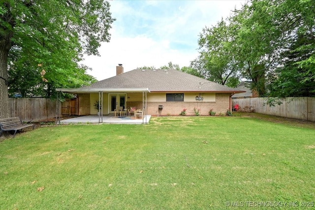 3948 S 93rd E Ave, Tulsa, OK 74145 - rear view of property with a patio, brick siding, a chimney, and a fenced backyard
