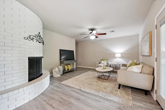 3948 S 93rd E Ave, Tulsa, OK 74145 - living area with wood finished floors, ceiling fan, a brick fireplace, and ornamental molding