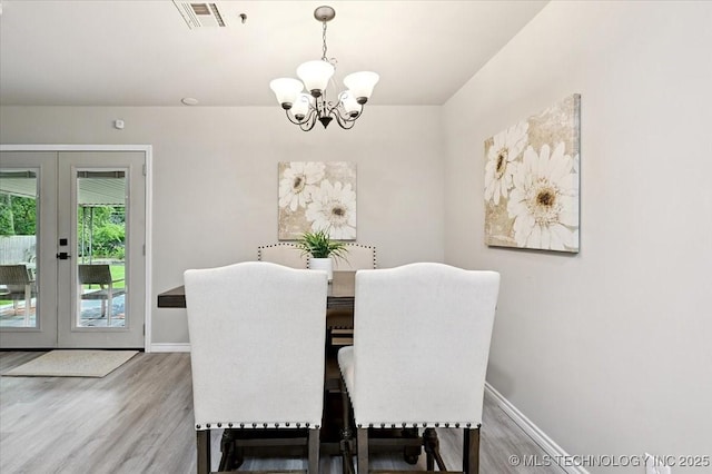 3948 S 93rd E Ave, Tulsa, OK 74145 - dining area featuring a chandelier, french doors, and wood finished floors