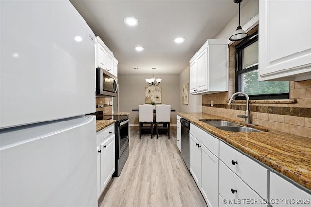 3948 S 93rd E Ave, Tulsa, OK 74145 - kitchen with stainless steel appliances, white cabinetry, decorative backsplash, light wood-style flooring, and pendant lighting