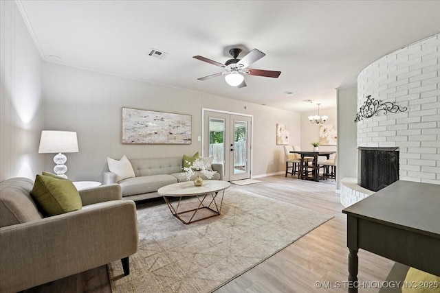 3948 S 93rd E Ave, Tulsa, OK 74145 - living area with wood finished floors, a ceiling fan, a chandelier, and french doors