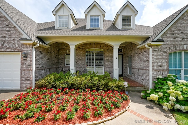 408 E 124th St S, Jenks, OK 74037 - entrance to property featuring covered porch, a shingled roof, and brick siding