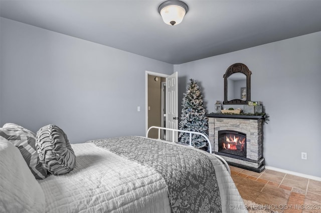 14908 E 88th St, Owasso, OK 74055 - bedroom with a stone fireplace and stone finish floors