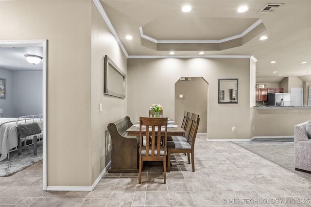 14908 E 88th St, Owasso, OK 74055 - dining area with crown molding, recessed lighting, a raised ceiling, and arched walkways