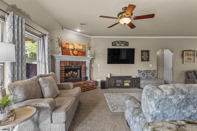 14908 E 88th St, Owasso, OK 74055 - living room with a fireplace, carpet floors, a ceiling fan, crown molding, and arched walkways
